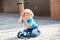 Little toddler boy riding on his bycicle in summer