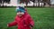 Little toddler boy tries to walk. Grass in park. Slow motion