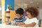 Little toddler girl and boy drawing together.  Asian boy and Mix African girl learn and play together in the pre-school class.