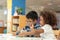 Little toddler girl and boy drawing together.  Asian boy and Mix African girl learn and play together in the pre-school class.