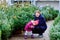 Little toddler girl and father holding Christmas tree on a market. Happy family, cute baby child daughter and middle