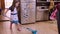 Little toddler girl mopping the kitchen floor