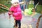 Little Toddler Girl Playing on Merry-Go-Round at Playground