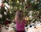 Little toddler girl standing near the Christmas tree