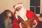 Little toddler girl talking to Santa Claus called Nikolaus or Weihnachtsmann in German. Happy smiling kid waiting for