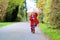 Little toddler girl walking with umbrella