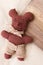 Little toy bear manually sewed by a child. Soft toy teddy bear sewn from fabric