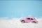 Little toy car rides in the snow, christmas transport concept