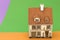 Little toy house on orange green backgrounds