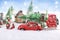 Little toy red car carrying christmas tree on the top