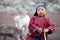 Little tsaatan boy posing with his family`s reindeer.