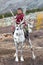 Little tsaatan boy riding with his family`s reindeer.