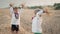 Little ukrainian children playing with hay, throw it up. Happy childhood. Smiling boys having fun at wheat field after