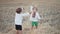 Little ukrainian children playing with hay, throw it up. Happy childhood. Smiling boys having fun at wheat field after