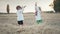 Little ukrainian children playing with hay, throw it up. Happy childhood. Smiling boys having fun at wheat field after