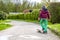 Little urban boy practicing with skateboard.