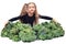 Little vegan girl sits and hugs huge pile of broccoli. healthy organic food concept