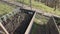 Little vegetables plants on raised beds in spring garden