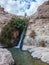 The little waterfall among rocks parched desert