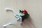 Little wedding boutonniere with roses with white ribbon