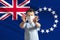 Little white boy in a protective mask on the background of the flag of Cook Islands. Makes a stop sign with his hands, stay at