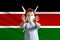 Little white boy in a protective mask on the background of the flag of Kenya Makes a stop sign with his hands, stay at