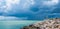 Little white house on the end of sea beach walkway and beautiful dark clouds background at Khao Lam Ya, Rayong, Thailand.