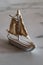 Little white sailboat decoration on a marble plate