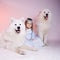 Little winter princess girl with dogs, symbol of new year