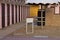 Little wooden board sign on the sand in a bathhouse with colored beach cabins in the background Italy, Europe