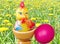 Little yellow chick and red Easter egg on the background of yellow dandelions. Easter is the oldest and most important Christian h