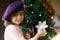 Little young girl decorating christmas tree