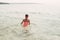 Little young girl swimming in lake river with underwater goggles. Child diving in water on a beach. Authentic real lifestyle happy