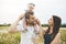 Littlegirl and his father and mother enjoying outdoors in field of daisy flowers