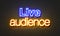 Live audience neon sign on brick wall background.