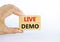 Live demo symbol. Concept words `live demo` on wooden blocks on a beautiful white background. Businessman hand. Copy space.