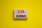 Live demo symbol. Concept words `live demo` on wooden blocks on a beautiful yellow background. Copy space. Business and live dem