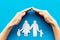 Live insurance concept. Family silhouette under palm on blue background top-down