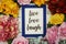 Live Love Laugh Card with colorful flowers border frame on wooden background