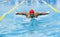 Live portrait of young sportive man, professional swimmer in goggles training at public swimming-pool, outdoors. Sport