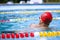 Live portrait of young sportive man, professional swimmer in goggles training at public swimming-pool, outdoors. Sport