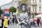 Live statue in a hat on the background of people, buildings and the flag of Croatia at the celebrat