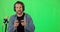 Live streaming, gaming and face of a man on a green screen isolated on a studio background. Mockup space, geek and