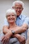 And they lived happily ever after. a happy senior couple standing outdoors while smiling at the camera.