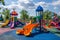 A lively childrens play area featuring vibrant slides and swings for kids to enjoy and have fun, A vibrant playground with a