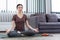 A lively girl doing meditate to keep calm mind and being relaxed as her indoor activity