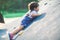 A lively little boy is playing a climbing game