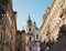 Lively Malaya Strana street overlooking the Church of Saint Nicholas