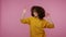 Lively vivid girl afro hairstyle in hoodie enjoying party music, moving in energetic dance, feeling carefree