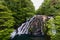 lively waterfall over red rocks, hidden in a forest in Patagonia along the Carretera Austral.